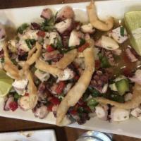Ensalada De Marisco · Octopus, shrimp, and calamari seasoned with red onions, green peppers, redpeppers, and lime.