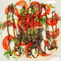 Caprese Salad · Fresh mozzarella, tomatoes, fresh basil, garlic, roasted red peppers & extra virgin olive oil.