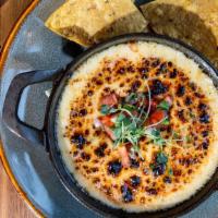 Hot Queso Dip · House blend queso, jalapeño, smoked paprika.