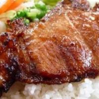 Cơm Sườn Nướng · Grilled pork chop and rice.