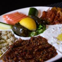 Meze Platter To Share · A variety of Paprica signature appetizer; haydari, hummus, shakshuka, stuffed vine leaves, b...