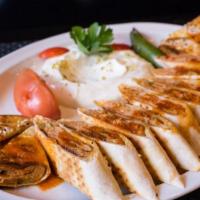  Lamb Beyti · Ground fresh baby lamb, grilled on skewer and served wrapped in lavash and topped with tomat...