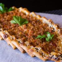 Pide With Cheese · House-made dough filled with feta cheese, mozzarella cheese and parsley; folded and baked in...
