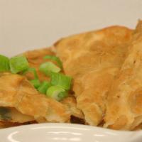 Pancake · Glutinous rice flour stuffed with scallions on herbs. Pan-fried until brown and served with ...