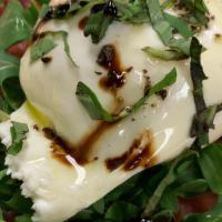 Burrata · Served on thinly sliced prosciutto, ripe tomatoes, basil, EVOO, balsamic glaze, and black pe...