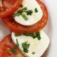 Mozzarella Caprese · With vine ripe tomatoes, EVOO balsamic glaze.