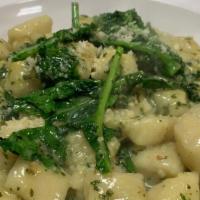 Gnocchi D'Este · With garlicky spinach, EVOO and broccoli rapi.