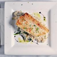 Cod Risotto · On a bed of spinach risotto.