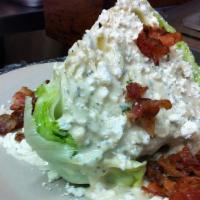 Classic Wedge Salad · Wedge of lettuce, tomato, bacon, gorgonzola crumbles, garlic parmesan dressing.