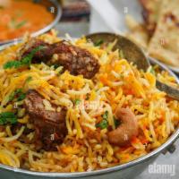Goat  Biryani · cooked with fresh baby goat in big pan ( daig) served with yogurt sauce  . in 32 oz platter