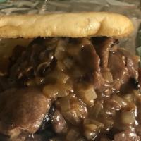Roast Beef · Hot roast beef served with sautéed onions and beef gravy on a keiser roll