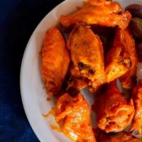Bbq Wings · 10 Large dry rubbed oven roasted wings tossed in a light sauce with creamy pesto dressing