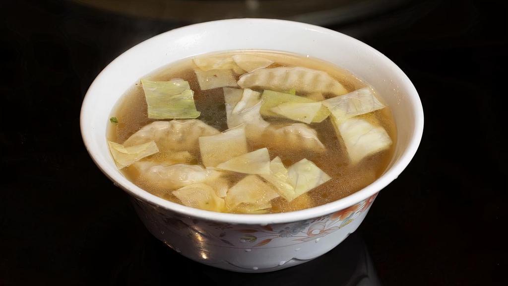 Dumpling Soup 饺子汤 · A broth-like soup containing pork dumplings and slices of round cabbage.