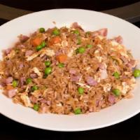 Pork Fried Rice 猪炒饭 · Chunks of ham fried with egg, green peas, carrots, onions, and cooked with rice to a golden ...