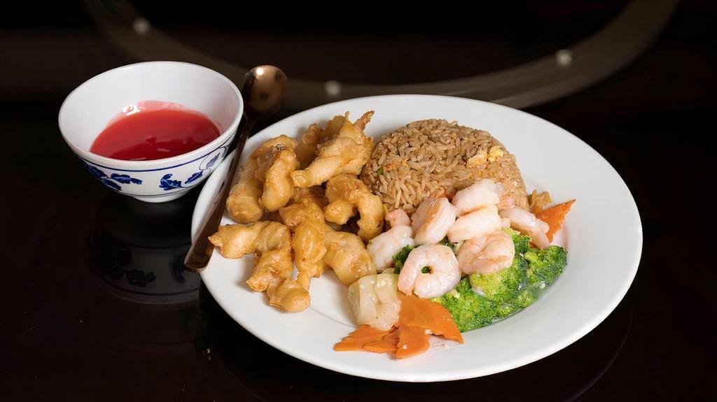 Shrimp With Vegetables Deluxe & Sweet And Sour Chicken Combination · Nutritious shrimp and assorted vegetable with sweet and sour chicken and an egg roll. This dish is shown with the sweet and sour sauce on the side.
