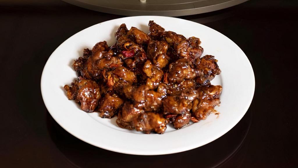 55-4. Orange Chicken (B) 陈皮鸡 · Our Chinese Orange Chicken is made with boneless skinless chicken breast, fried until golden and crispy, and then generously layered with our homemade orange sauce.