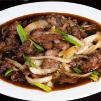 Mongolian Beef 蒙古牛 · Thin cuts of beef stir-fried with green and white onion,  caramelized in luscious, sugary Mo...