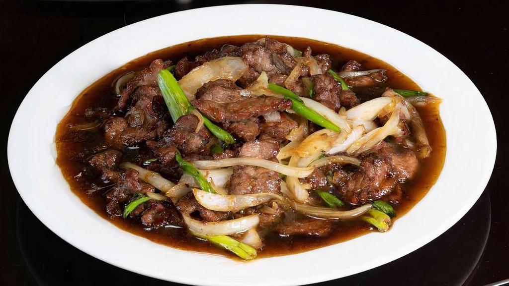 Mongolian Beef 蒙古牛 · Thin cuts of beef stir-fried with green and white onion,  caramelized in luscious, sugary Mongolian sauce.