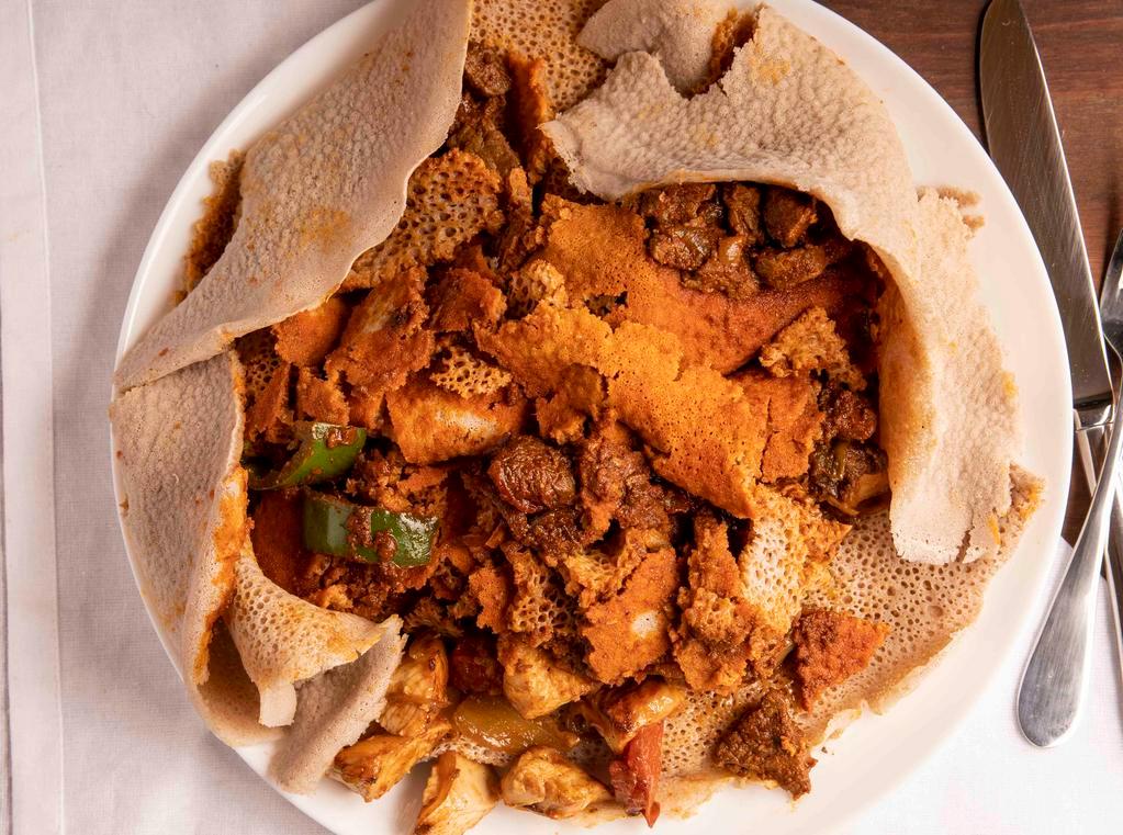 Timatim Fit-Fit (Served Cold) · Pieces of injera soaked in tomato and jalapeno juices.