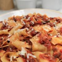 Fetuccini Bolognese · Pappardelle pasta with grounded beef, basil, carrots, and celery finished in red wine tomato...