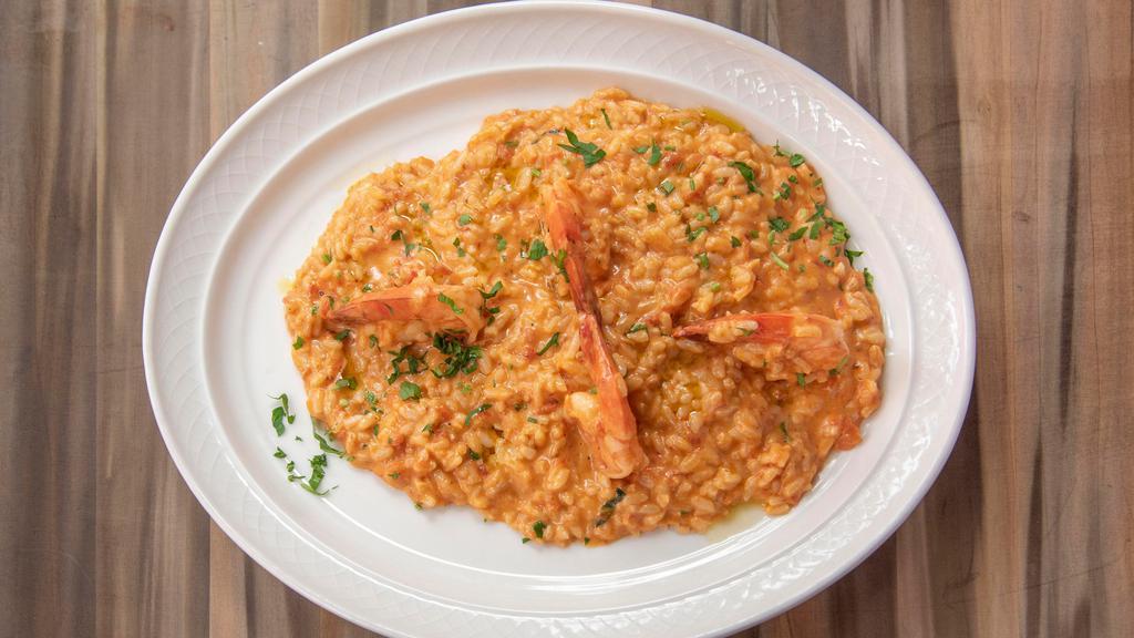 Risotto Agli Scampi · Arborio rice sautéed with extra virgin olive oil w/ garlic and shrimp, in a pink cognac sauce.