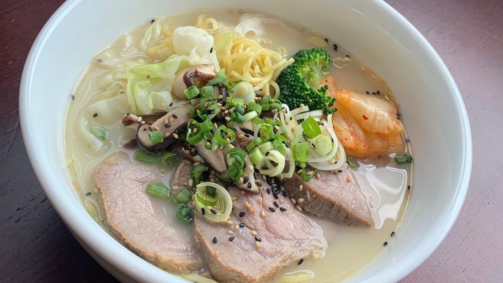 Tonkotsu Ramen · Includes pork chashu, cabbage, wakame, scallions, sesame seeds, red ginger, egg
