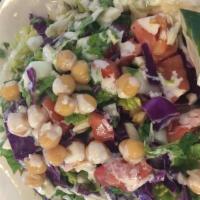 Israeli Salad · Finely chopped tomatoes, cucumbers,  romaine lettuce, purple cabbage, chickpeas and tahini.