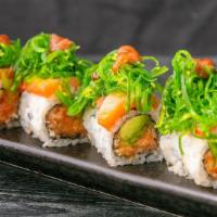Green River Roll · Crunchy spicy salmon and avocado with seaweed salad and smoked salmon on top.