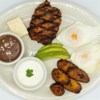 Desayuno Salvadoreño · Two sunny side up eggs, fried plantains, fresh cheese, rice, refried beans, source cream, ch...