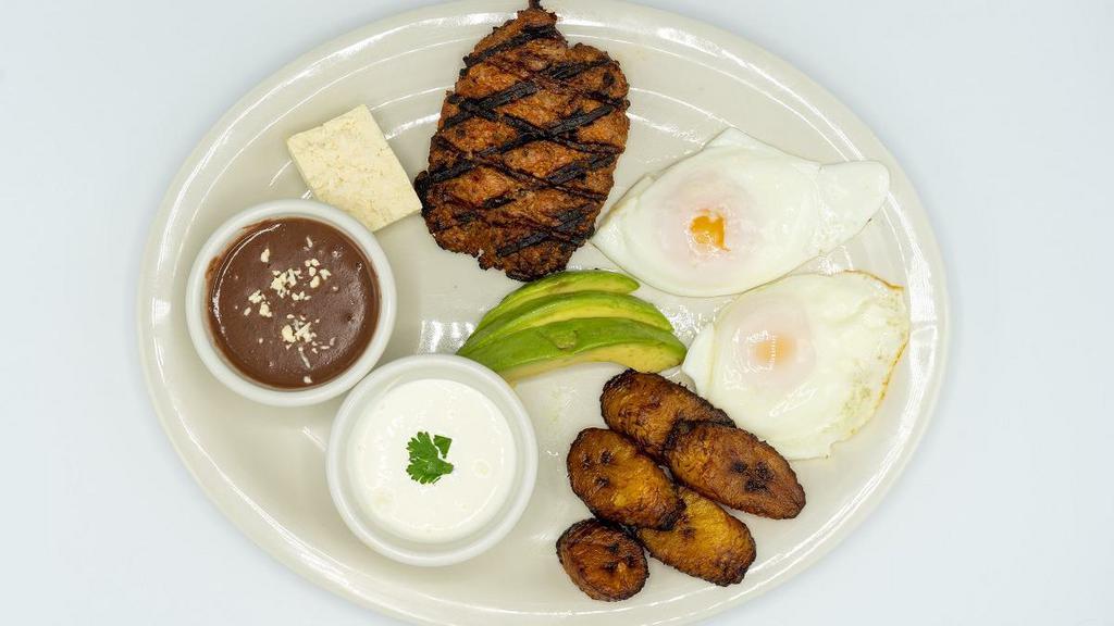 Desayuno Salvadoreño · Two sunny side up eggs, fried plantains, fresh cheese, rice, refried beans, source cream, chorizo sausage and avocado.