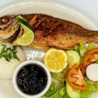 Pescado Frito · Fried red snapper served with rice, beans and salad.