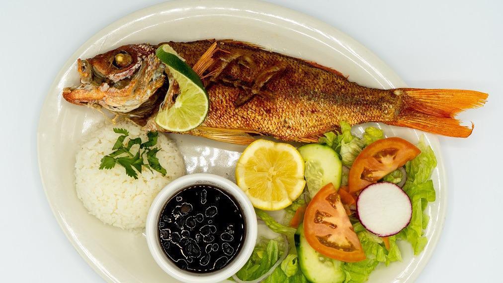 Pescado Frito · Fried red snapper served with rice, beans and salad.