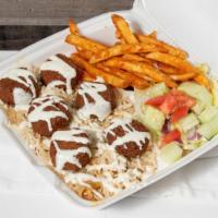 Falafel Over Rice · Fried Falafel Balls Over Seasoned Rice Served With, House salad,& Seasoned Fries. Try Our Co...