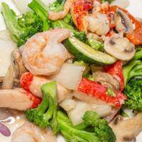 Seafood Delight · Combination of lobster meat, jumbo shrimp, sea scallop & crabmeat mixed veg. in a white sauce.