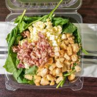 Spinach Salad · Handpicked spinach leaves, crispy real bacon, chopped hard boiled eggs, and homemade baked c...