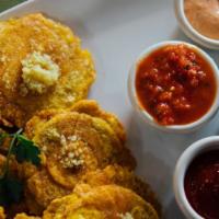 Tostones · Fried mashed green plantains with an assortment of homemade sauces included.