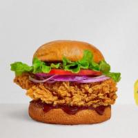 Lone Wolf Chicken Sandwich · Crispy fried chicken, bacon, cheddar cheese, lettuce, and BBQ sauce served on a golden hero ...