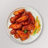 Classic Buffalo Wings · Fresh chicken wings breaded, fried until golden brown, and tossed in buffalo sauce. Served w...