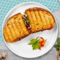 Turkey Supreme Panini · Turkey, bacon, Swiss cheese, lettuce, and tomato served on a flat panini bread.