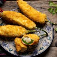 Stuffed Jalapeño Poppers · Spicy jalapeño peppers stuffed with cheese
and fried until golden brown.