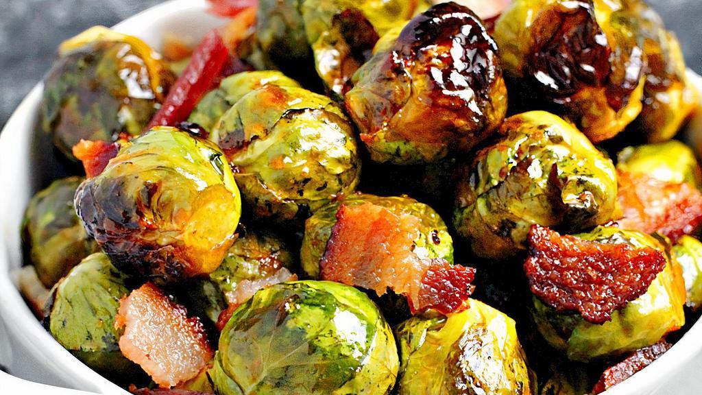 Honey Glazed Brussel Sprouts · Quarter cut brussels sprouts flashed fried in bacon juice, tossed with a sweet n spicy honey and topped with crispy bacon.