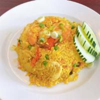 Pineapple Fried Rice · Fried rice with chicken, shrimp, egg, pineapple chunk, onions, pea, carrot, and raisin in a ...