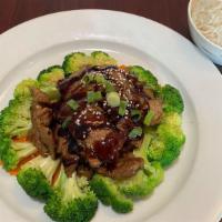 Beef Teriyaki · Grilled beef drizzled in teriyaki house sauce served with steamed broccoli, carrot, and blac...