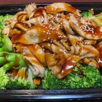 Chicken Teriyaki · Grilled chicken drizzled in teriyaki house sauce served with steamed broccoli, carrot, and b...