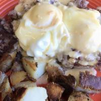 Irish Benedict · Two dropped eggs on hash on an English muffin with benedict sauce on top, served with home f...