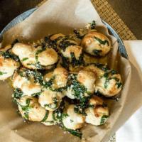 Garlic Knots · House-made dough, tied up, dipped in garlicky goodness & oven-baked. Served with warm specia...