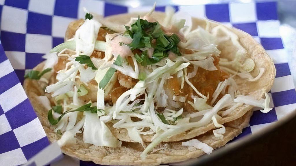Fish Tacos (2) · Lightly fried Alaskan pollock served with shredded cabbage and creamy red salsa.