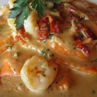 Lobster Ravioli (Lunch) · Sun-dried tomatoes, baby shrimp, and brandy cream sauce.