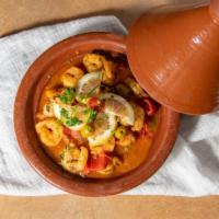 Shrimp Tagine · Peppers, Cherry Tomatoes , onions , garlic and Green Olives  cooked in Moroccan spices
