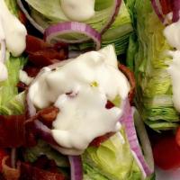 Wedge Salad · Bacon, tomato & red onion. Blue cheese dressing.